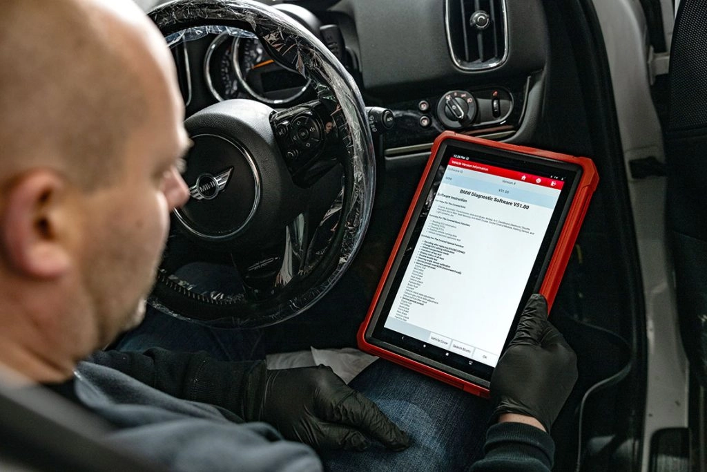 Technician scanning vehicle diagnostics